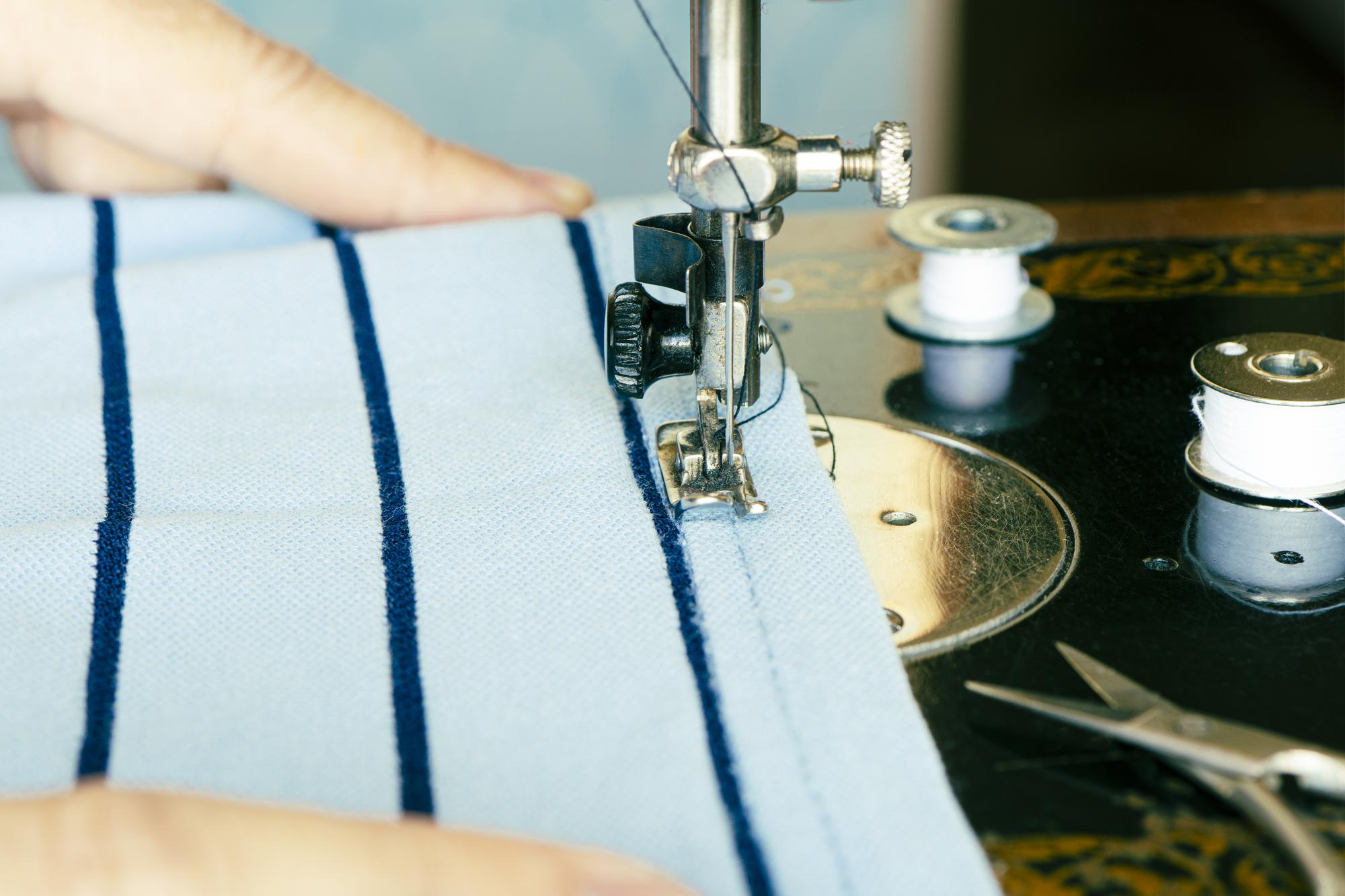 Embroidery machine stitching a monogram on fabric
